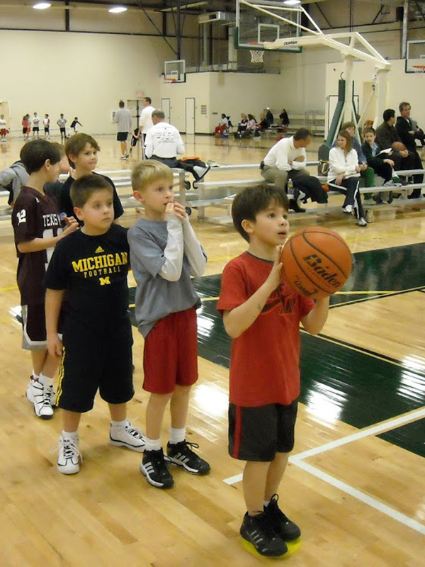 Boys Play Basketball in a Sports Complex