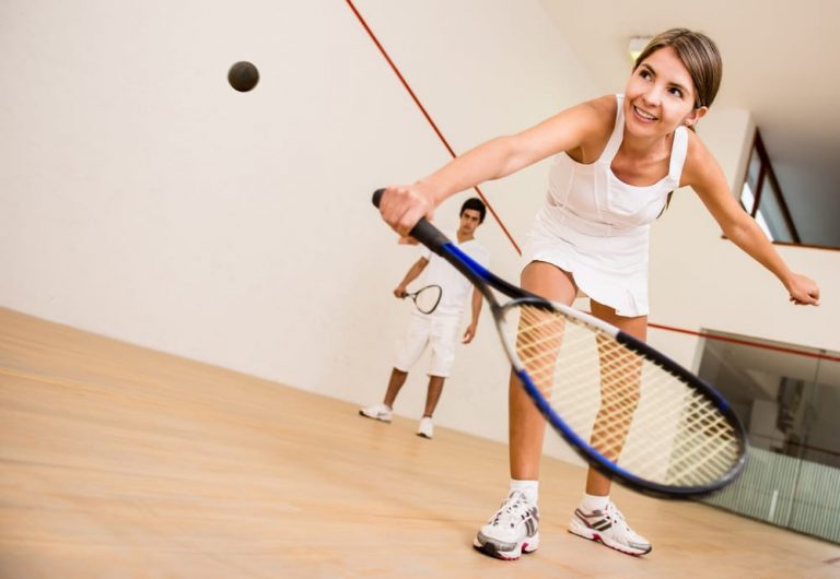 A Woman Plays Squash at a Recreation Center