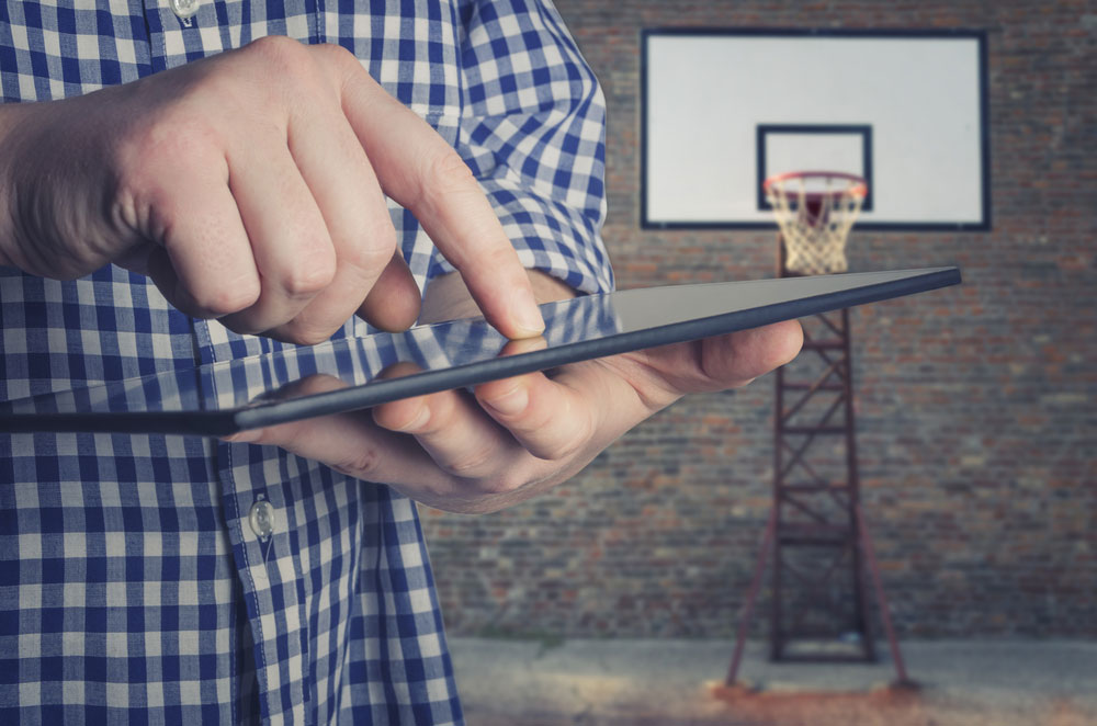 Coach using tablet on basketball court