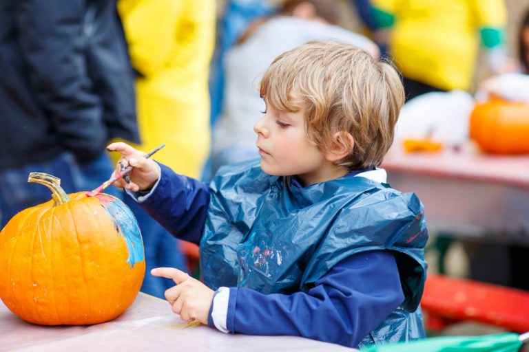 Child painting a pumpkin