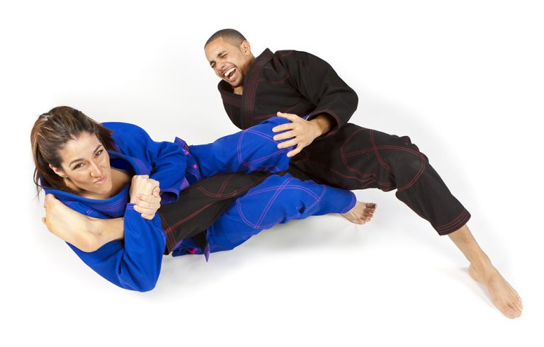 Two people practicing jiu-jitsu submission