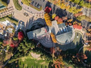 Aerial view of the Ramon Community Center, San Ramon, California, USA, showcasing its unique architecture and surrounding fall foliage. The image captures the center's design with nature.