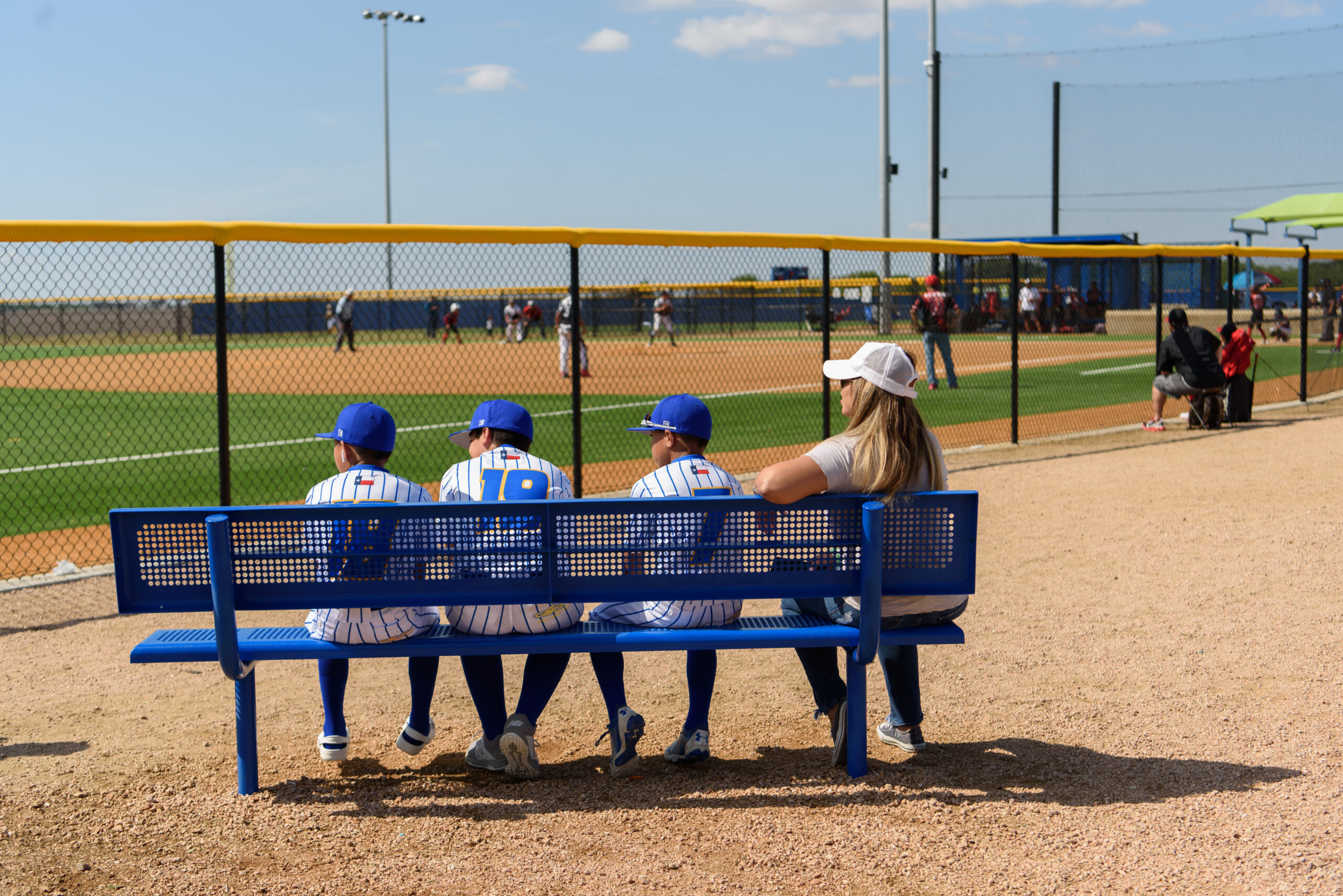 Baseball players sitting on a bench at a SFC managed venue